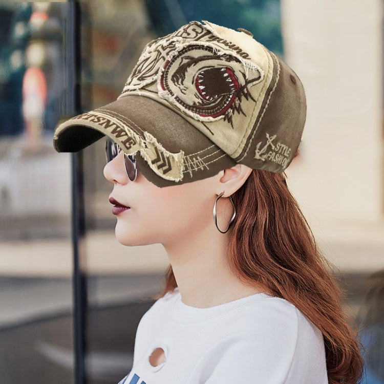 Beige baseball cap with embroidered shark patch and contrasting side brim stitching