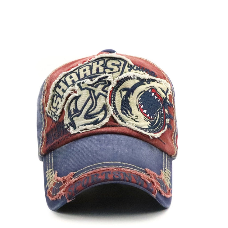 Red and denim baseball cap with embroidered shark graphic patch on the front