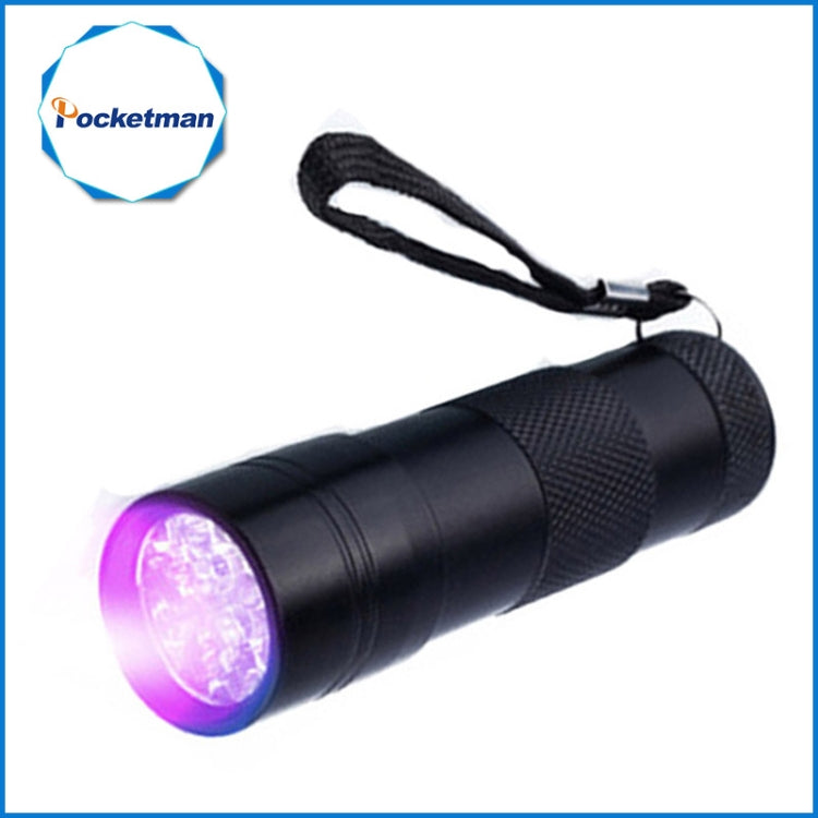 Mini UV flashlight in black with wrist strap, emitting a purple UV glow