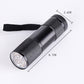 Black compact UV flashlight with textured grip and front lens, with wrist strap