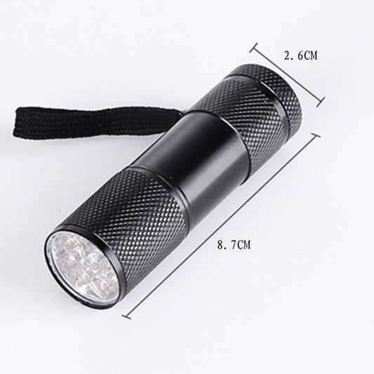 Black compact UV flashlight with textured grip and front lens, with wrist strap