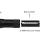 Black UV flashlight with tail cap open and battery holder for 3x AAA batteries