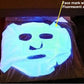 Mini UV flashlight shining purple light that reveals fluorescent marks on paper