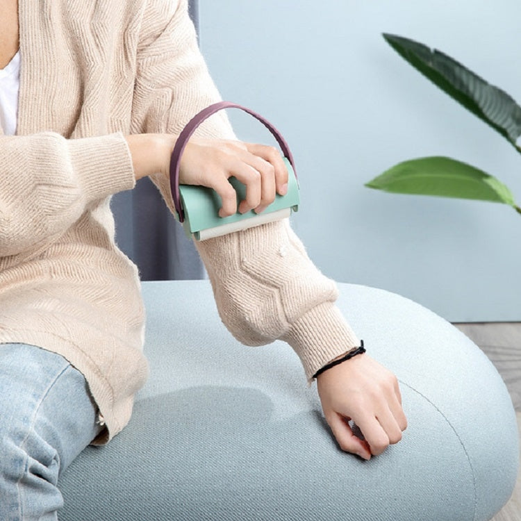 Handheld sticky lint roller brush, teal base with purple loop handle