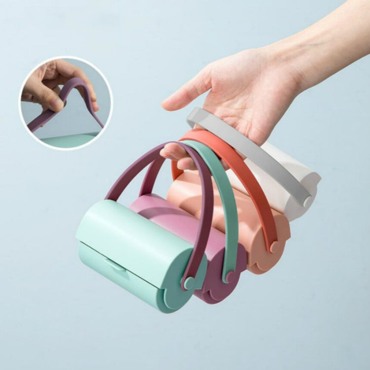Handheld sticky lint roller brush, teal base with pink roller and multicolor loop straps