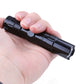 Black pocket flashlight in hand with ribbed body and open lanyard/keychain end