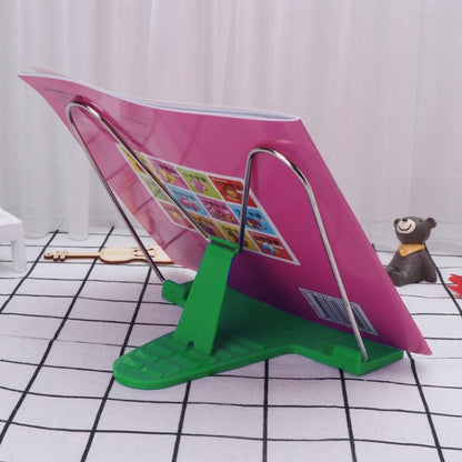 Green adjustable book stand with metal wire frame, angled for reading