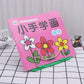 Pink workbook on green metal wire book stand, angled for reading