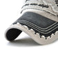Cotton baseball cap brim close-up with tiger text embroidery and stitched distress, dark/cream