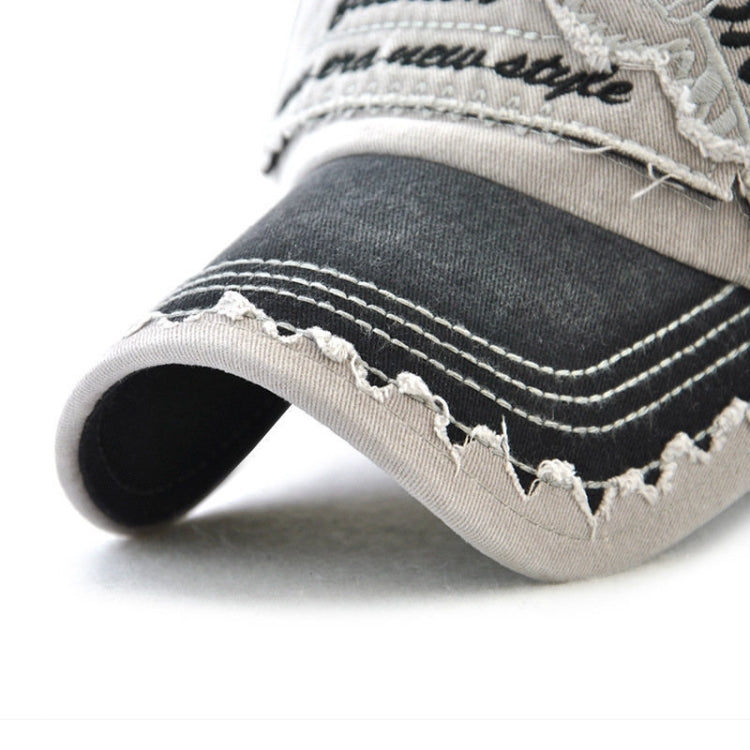 Cotton baseball cap brim close-up with tiger text embroidery and stitched distress, dark/cream