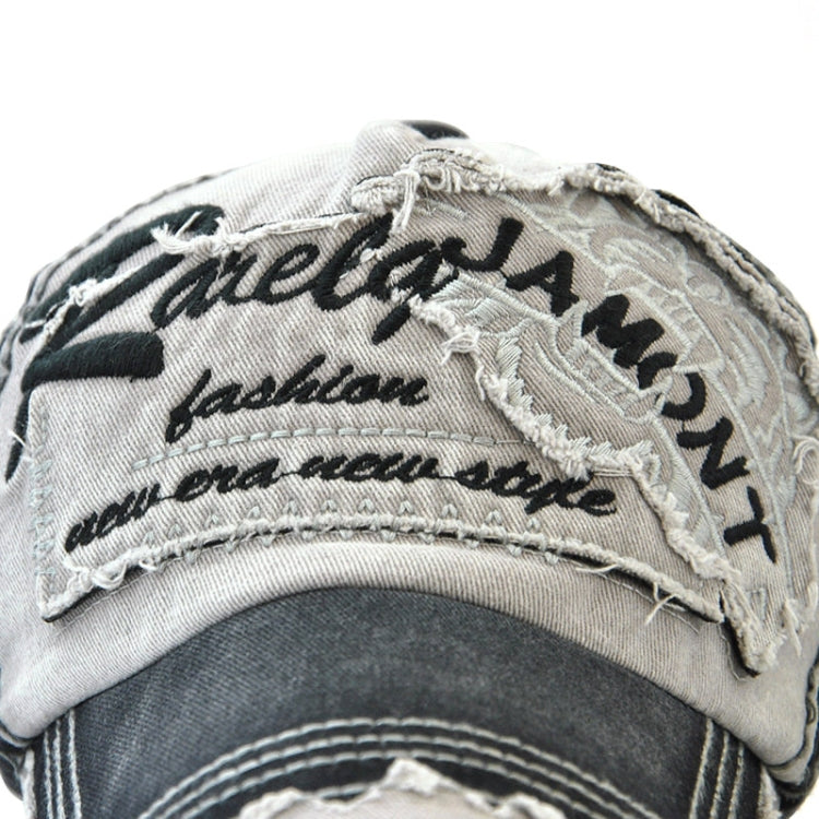 Cotton baseball cap close-up with tiger head embroidery and stitched text, light/black