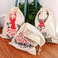 Cream linen drawstring Christmas gift bag with deer and "Merry Christmas" prints, plus folded bag