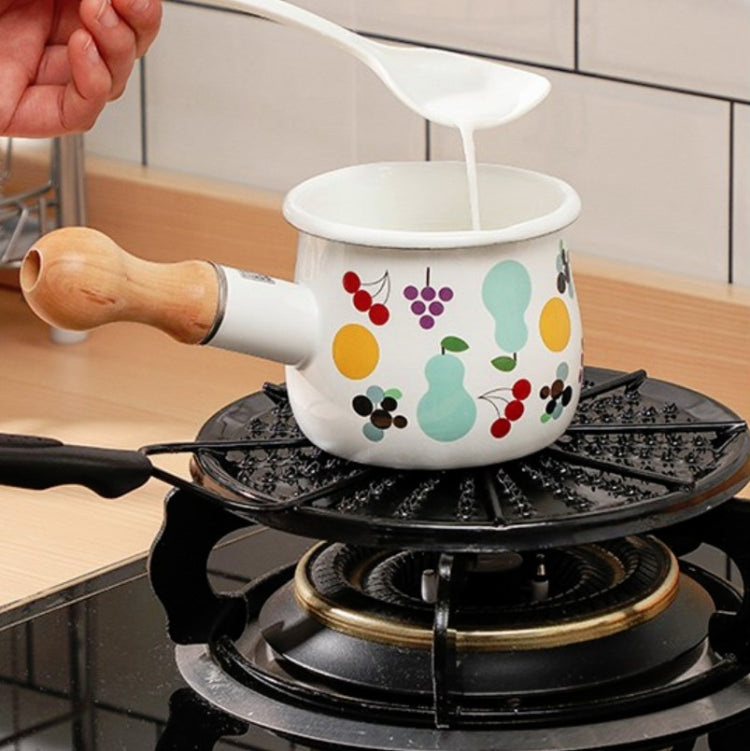 Black heat plate on gas stove with small patterned pot heating on burner