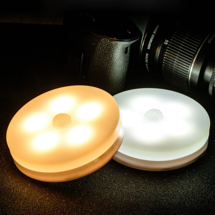 Pair of round LED night lights showing warm amber and cool white light modes