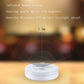 White round LED night light with built-in sensor, emitting soft white glow