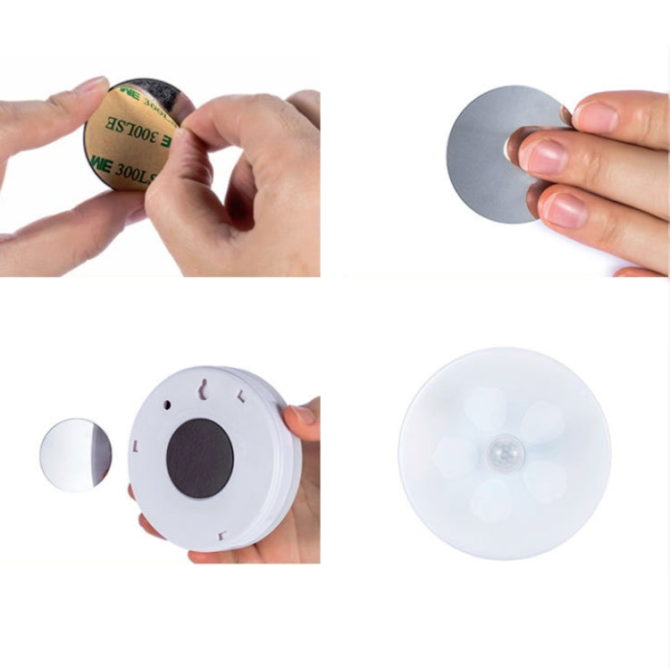 Round LED night light with hand-held battery install and underside button view