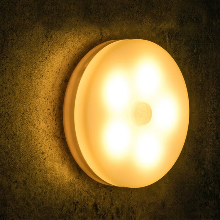 Round wall LED night light with warm amber glow on a circular bezel