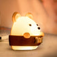 Close-up bear-shaped night light wall lamp with orange cradle, warm glow