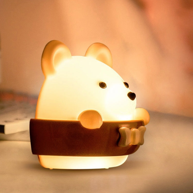 Close-up bear-shaped night light wall lamp with orange cradle, warm glow