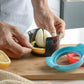 Egg slicer cup with black insert and red ring, holding a sliced hard-boiled egg