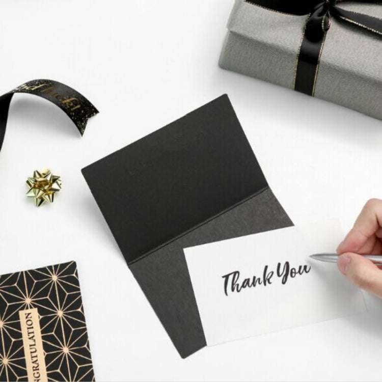 Black and white thank-you card with gold foil border, held by hand, with small star charm