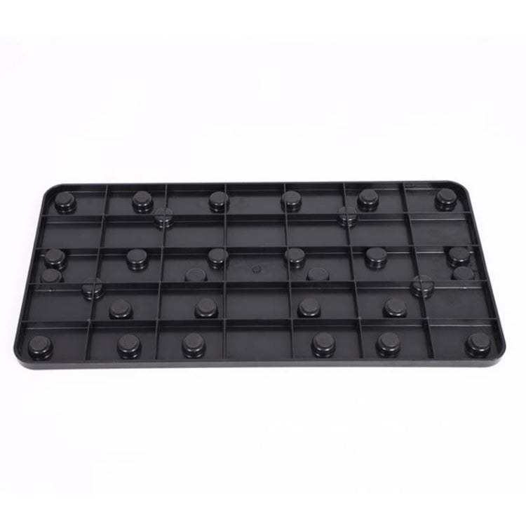 Black underside of push-up stand with embedded raised pads across the base