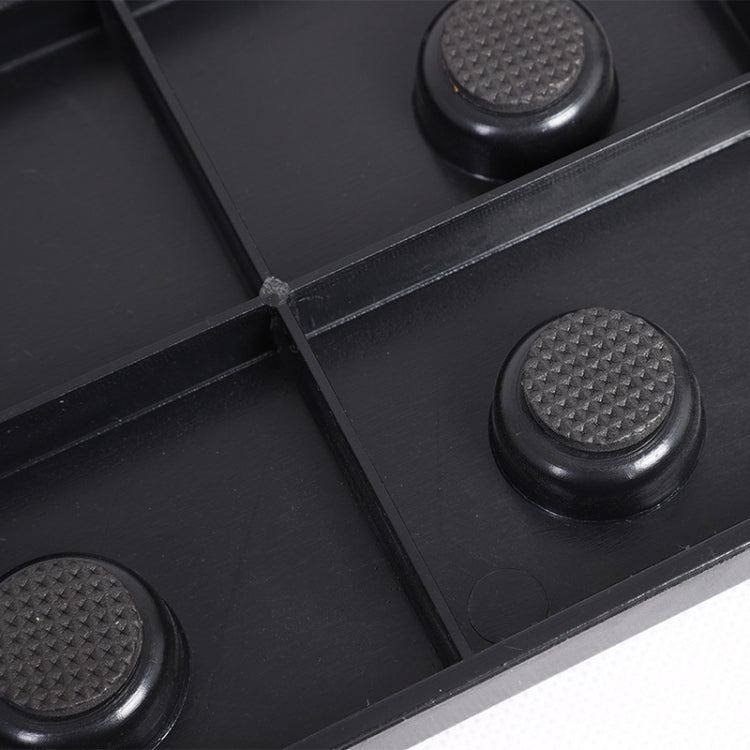 Close-up of black rubber feet on the push-up stand base for stability