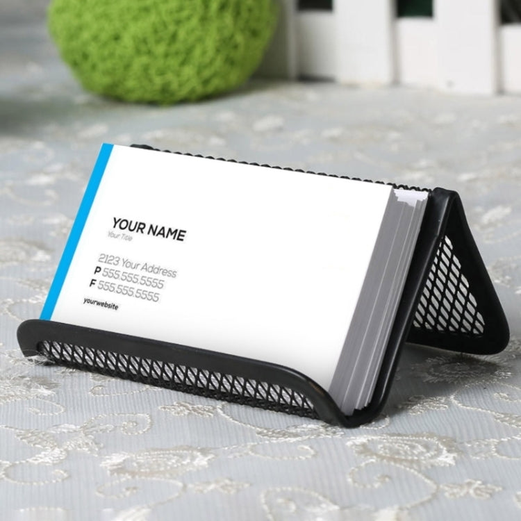 Black metal mesh business card holder holding a white business card