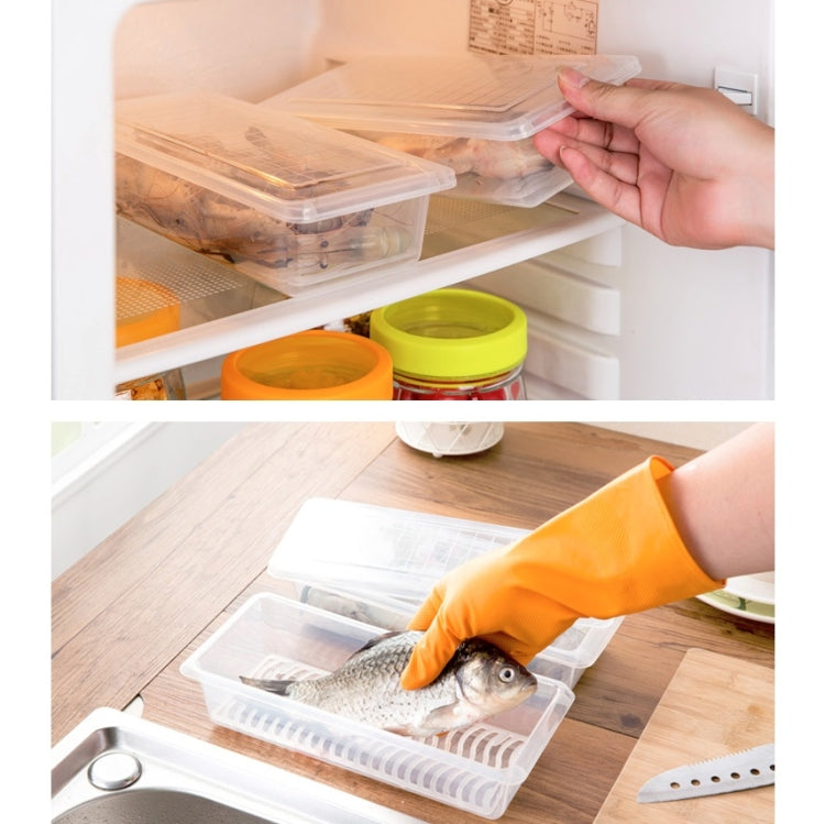 Clear plastic fresh-keeping box with fish, hand lifting from refrigerator shelf