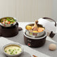 Brown electric lunch box with steaming stainless pot and sliced vegetables and eggs