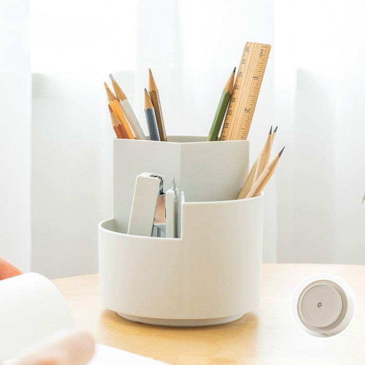 Rotating pen holder with round base, open compartments holding pencils and pens.