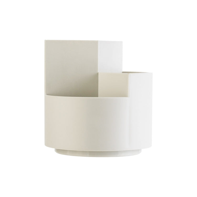 Rotating pen storage box with three-section design and round base in light color.