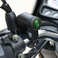 Motorcycle LED waterproof switch near handlebars, green indicator on black housing