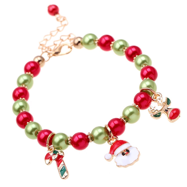Beaded Christmas charm bracelet with red and green beads, Santa face and reindeer dangle charms