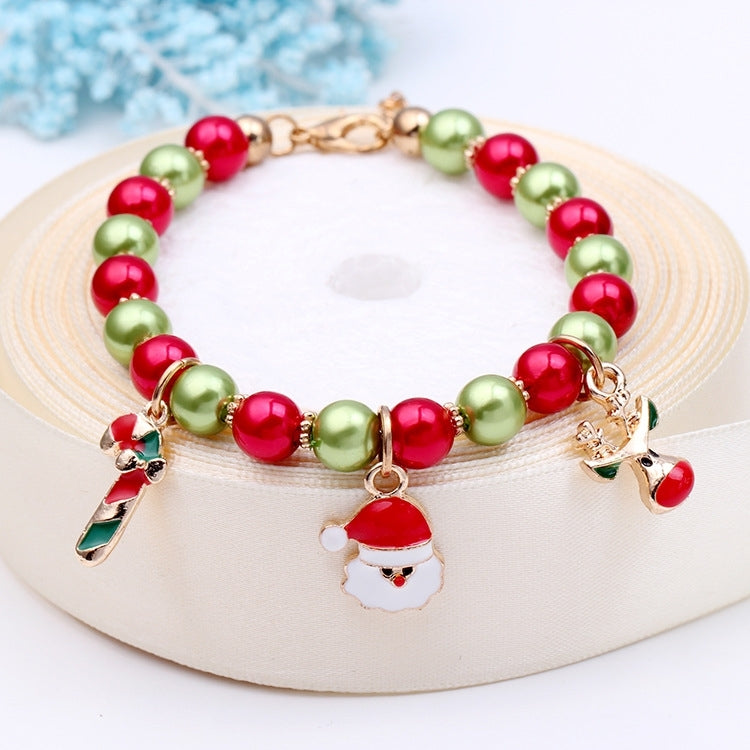 Beaded Christmas charm bracelet with red and green beads, Santa face and reindeer charms
