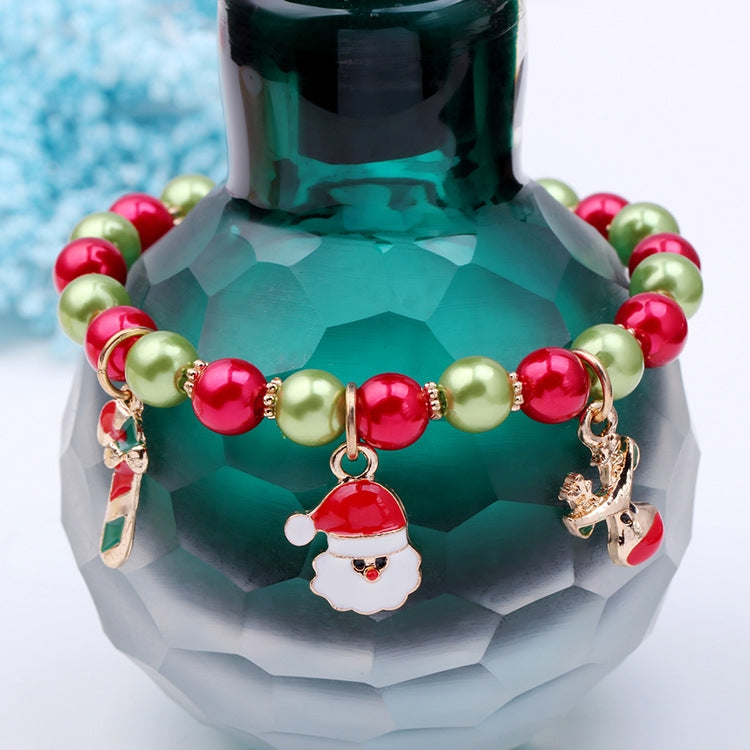 Beaded Christmas charm bracelet with red and green beads, Santa face and reindeer charms