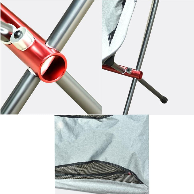 Close-up of outdoor folding chair frame with red connector and light gray fabric