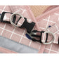 Pink grid pet chest harness with metal rings, black connectors, and leash buckles