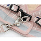Pink grid pet chest harness with metal D-rings, black strap buckles, and leash clips