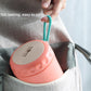 Coral-orange stainless steel soup cup thermos in a bag, carrying handle visible