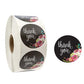 Thank you seal sticker roll with dark round floral stickers reading “thank you”