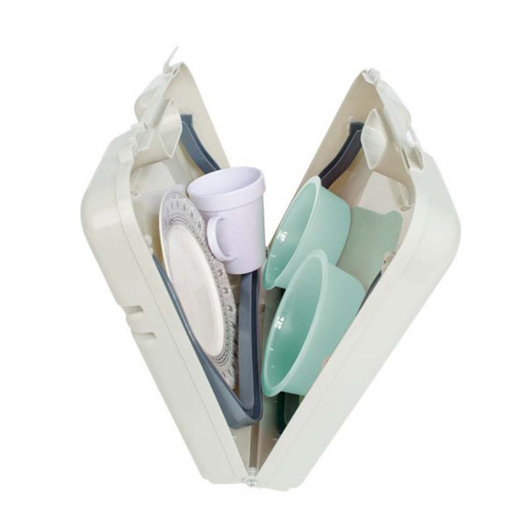 Folding table with open base holding stacked plates and cups