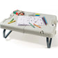 Folding table with legs extended, light gray top with drawing pad and markers