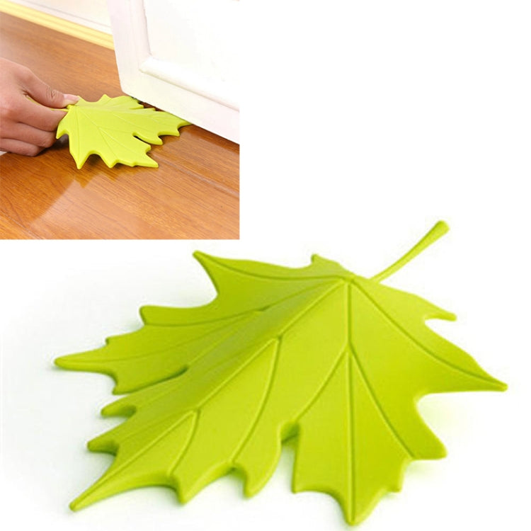 Green maple-leaf door stop with stem for gripping and preventing door closure