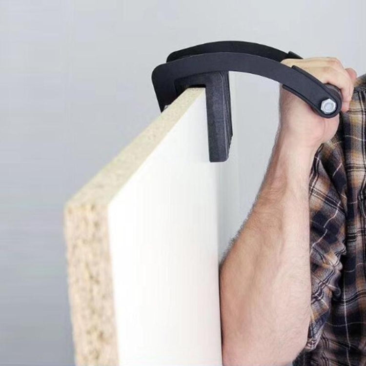 Black wood board clip secured on board edge with gray handle and metal knob
