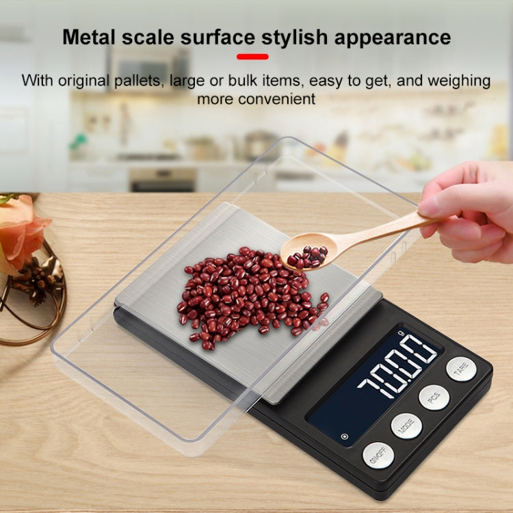 Mini electronic scale with clear protective cover on brushed metal platform