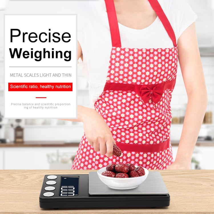 Portable digital scale on countertop with brushed metal platform and blue LED display