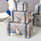 Gray and white wooden jewelry storage box with stacked tiers, bird and rope handles