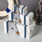White wooden jewelry storage box set with blue net panels, starfish accents, rope handles