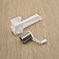 Plastic hand-crank rotary grater with stainless shredding drum on wooden surface